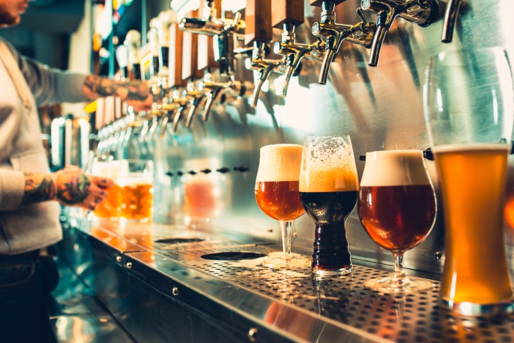 A row of craft beers on a counter