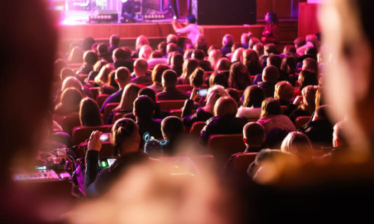 silhouettes of people enjoying a theater perfromance